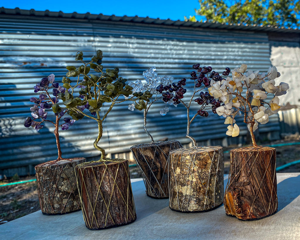 Custom one stone mini wire tree sculpture examples. Left to right: Amethyst on copper wire, olive jade on brass wire, clear quartz on nickel silver wire, garnet on silver nickel wire, yellow calcite on bronze wire.